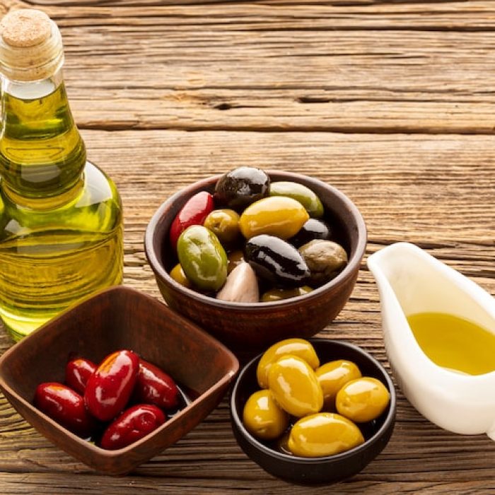 high-angle-olive-bowls-bread-slices-oil_23-2148349418